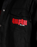 Close-up of the red Kill la Kill logo embroidery on the black denim chest pocket.