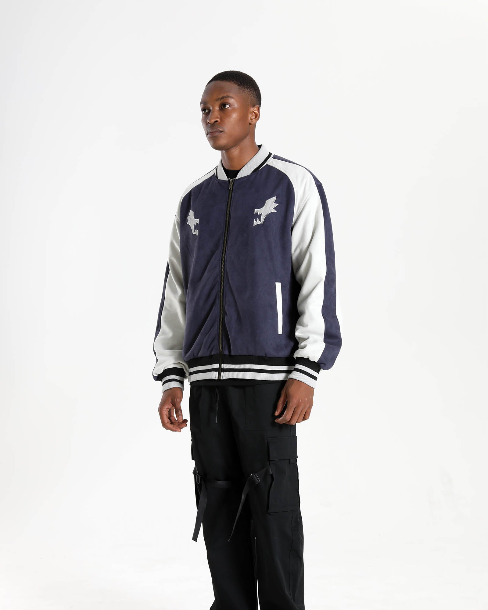 Studio shot of a model wearing the Kill la Kill Ryuko reversible bomber jacket as oversized anime streetwear