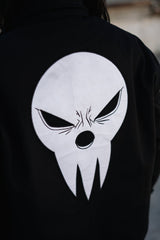 Detailed close-up of the white Shinigami mask embroidery on the back
