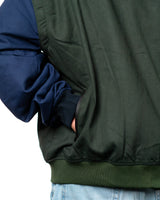 Naruto Shippuden Jonin Jacket back detail showing green fabric texture, navy sleeve, ribbed cuff and hem band