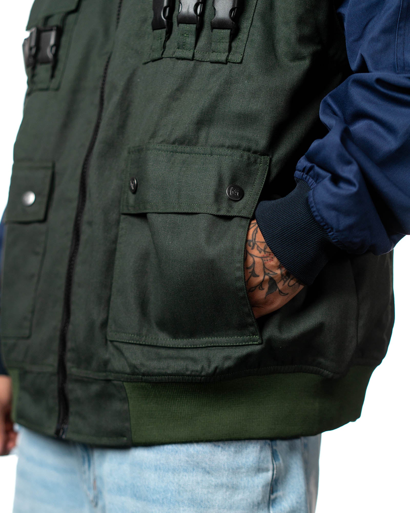 Close-up of the Naruto Shippuden Jonin Jacket front utility pockets, snap flaps, black buckles and navy sleeve fabric