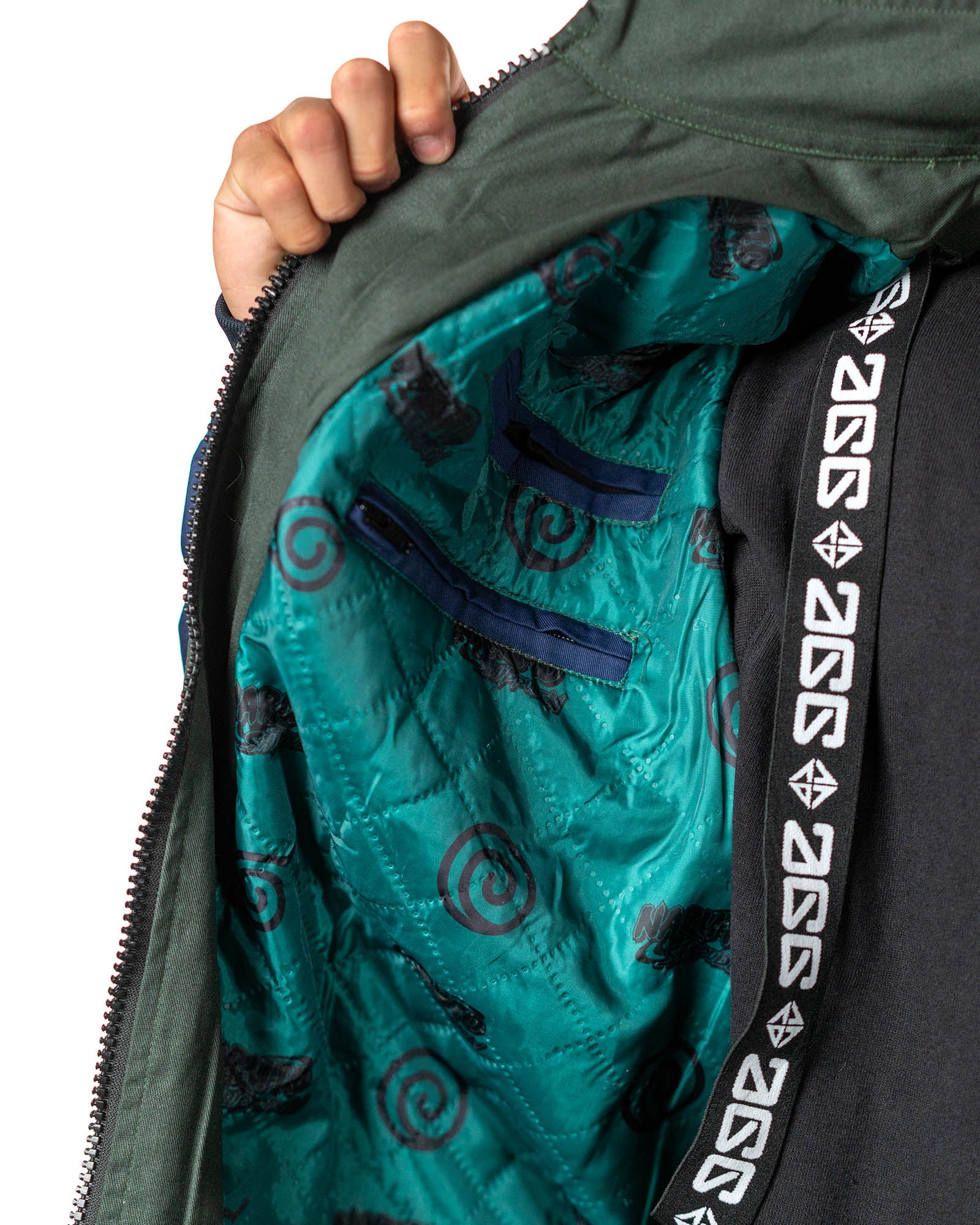 Naruto Shippuden Jonin Jacket interior detail with teal quilted lining, Uzumaki spiral print and branded neck tape