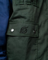 Close-up of the Naruto Shippuden Jonin Jacket pocket flap with black Hidden Leaf embroidery and silver snap buttons