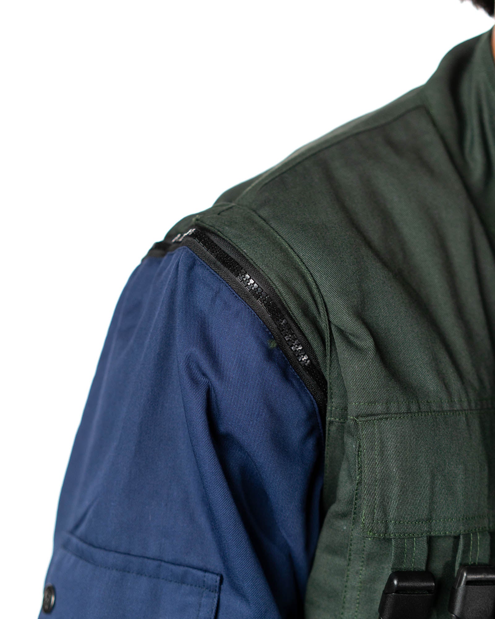 Naruto Shippuden Jonin Jacket shoulder close-up showing the removable sleeve zipper, green vest panel and navy sleeve