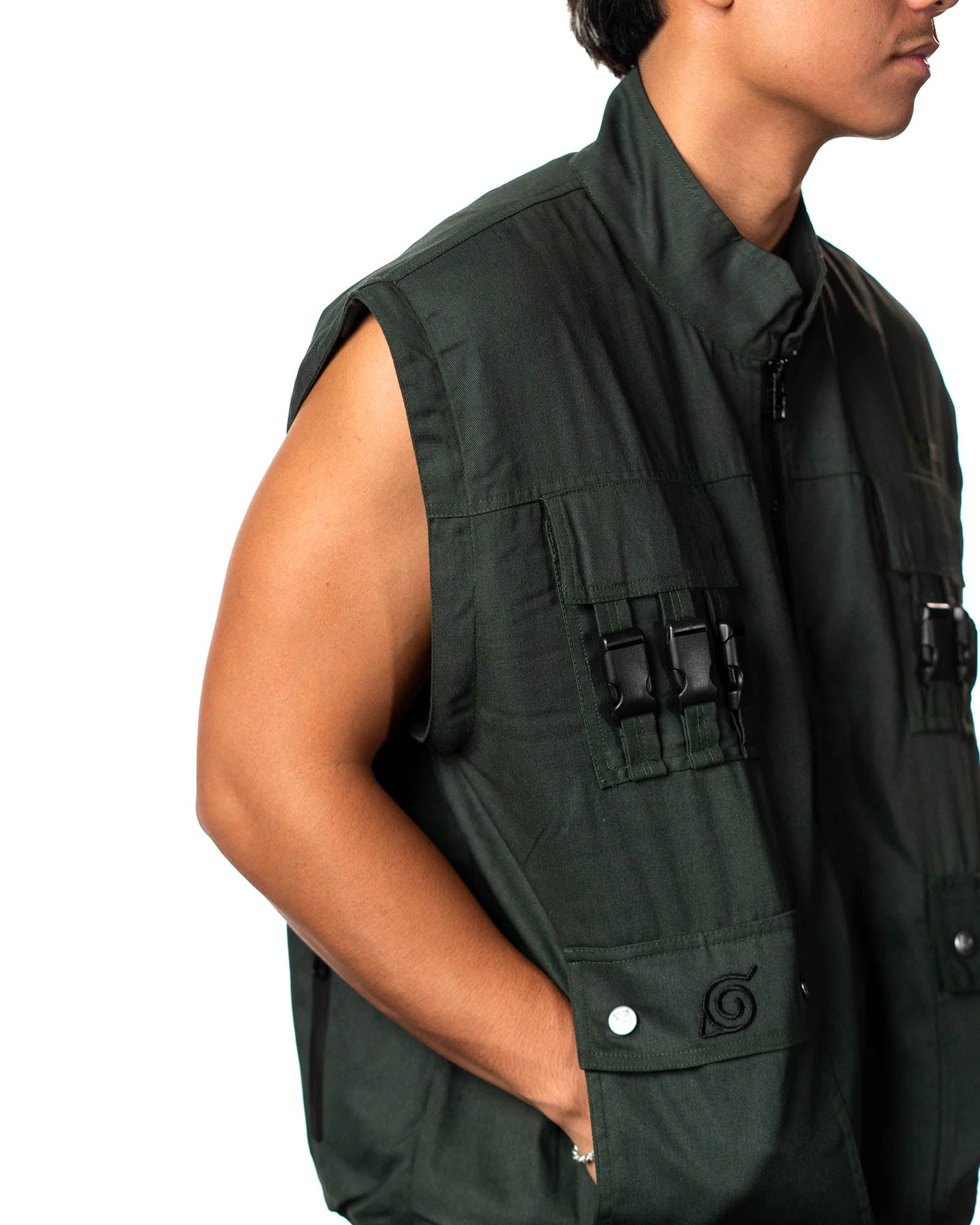 Naruto Shippuden Jonin Jacket side pocket close-up with Hidden Leaf embroidery, snap buttons and green cotton fabric