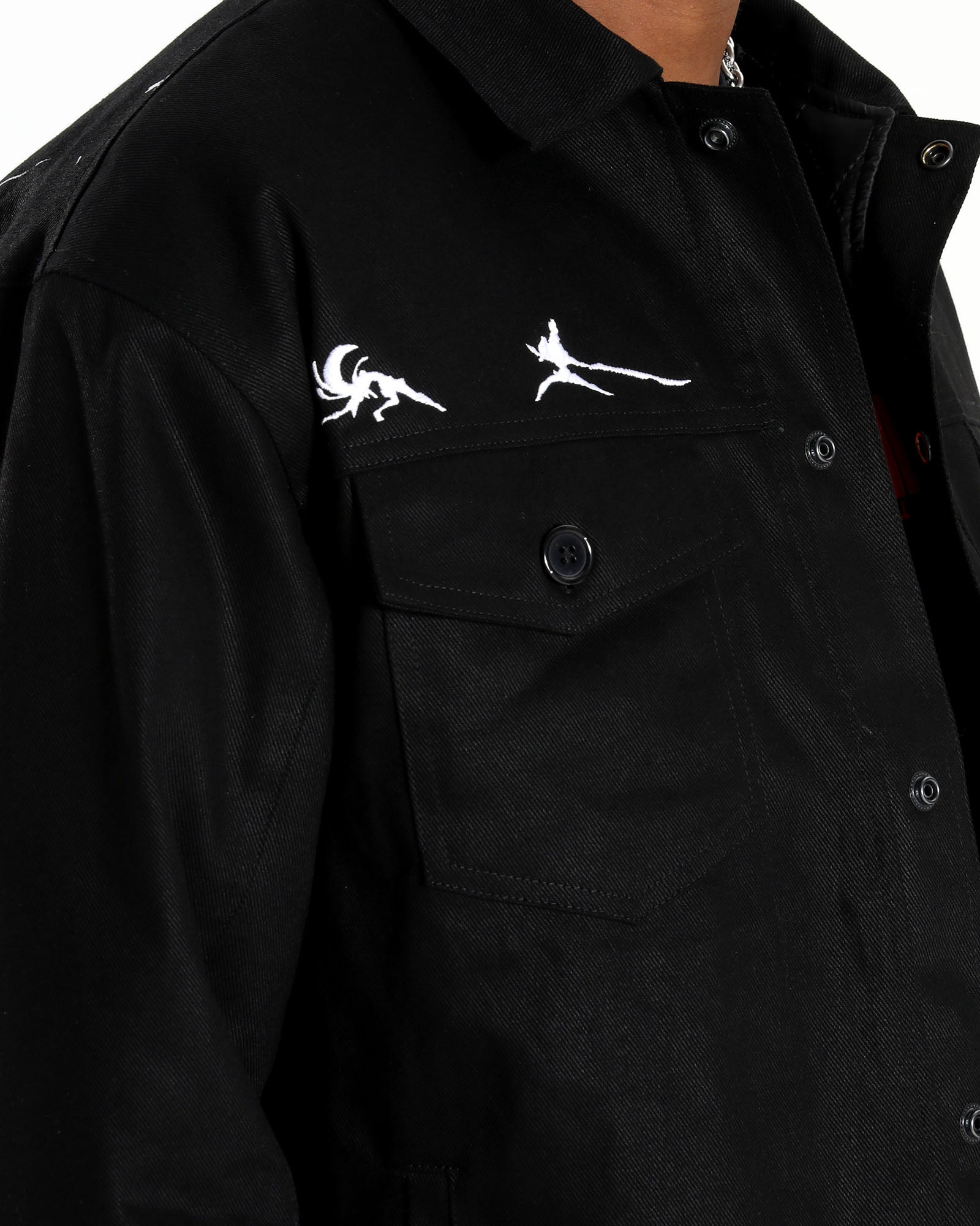 Detail shot of the white Ryuko silhouette embroidery on the upper chest.