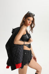 Side profile shot of the black denim jacket highlighting the shoulder straps.