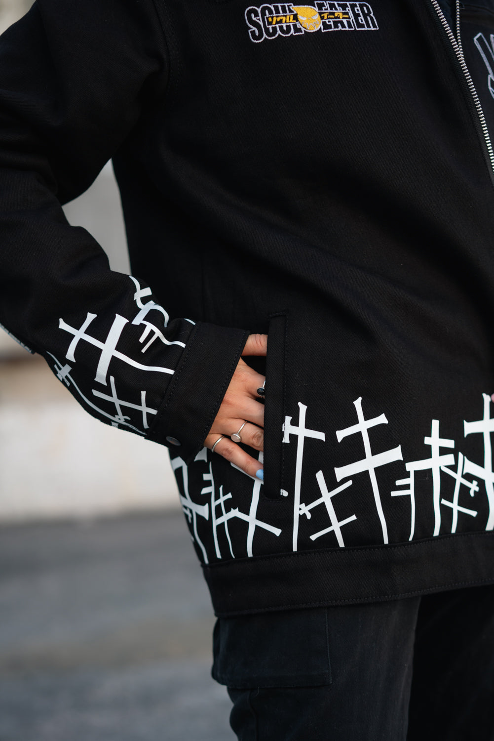 Close-up of the white cross graveyard pattern on the jacket cuff and sleeve