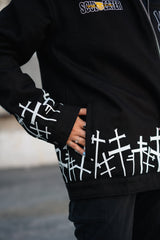 Close-up of the white cross graveyard pattern on the jacket cuff and sleeve