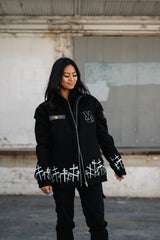 Full-length shot of the oversized Soul Eater jacket styled with black cargo pants