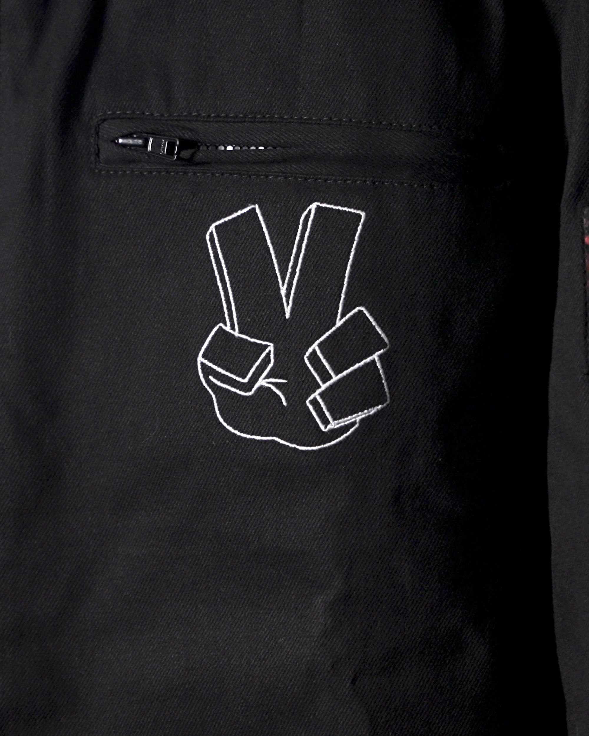 Zoomed-in shot of the chest pocket area and Shinigami Hand embroidery