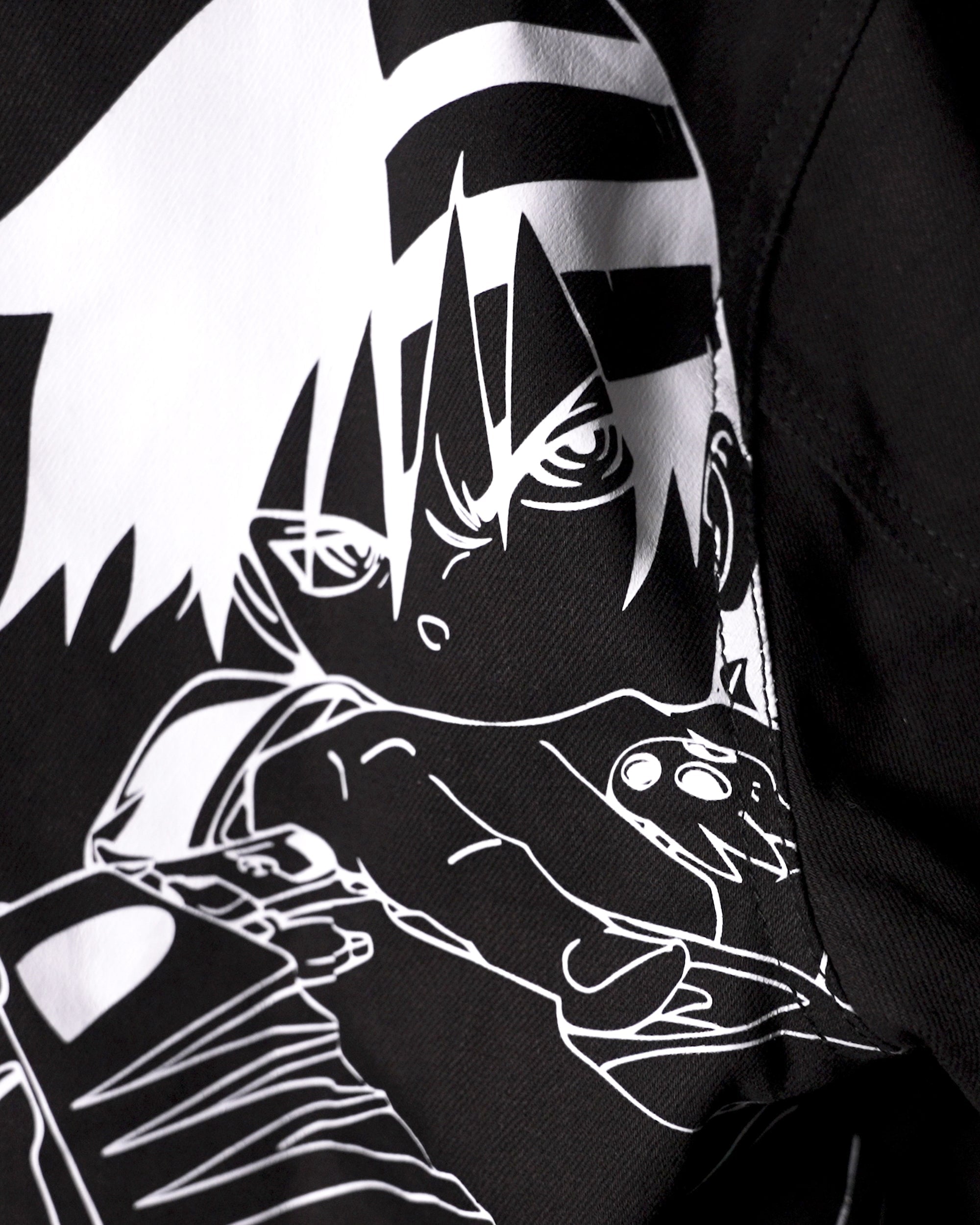 Close-up detail of the high-contrast white line art embroidery of Death the Kid.