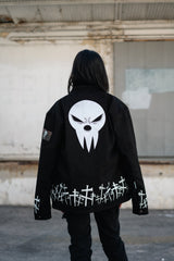 Distant back view of the jacket highlighting the reflective white embroidery