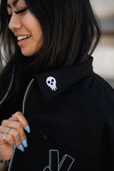 Close-up of the jacket collar and zip-up front with model smiling