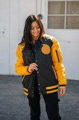 Front view of the yellow and black Soul Evans Bomber Jacket on a female model.