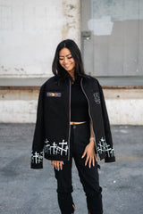 Female model wearing the unzipped Soul Eater jacket over a black crop top